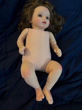 Realistic Baby Doll in Pale Pink Bodysuit